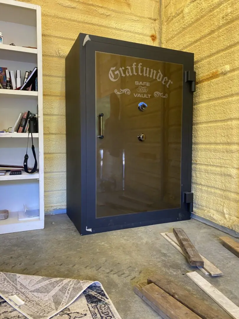 A large black safe sitting in the corner of a room.