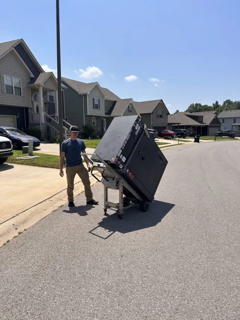 A man is moving furniture in the street