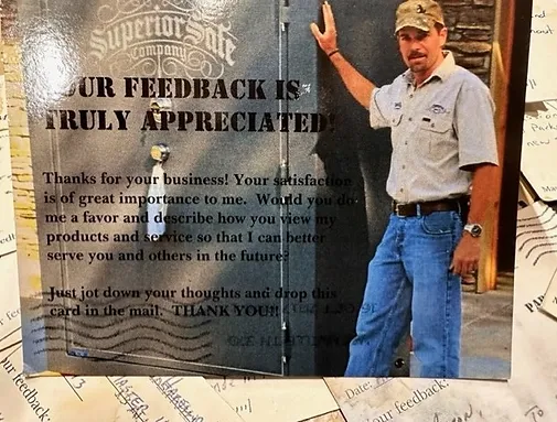 A man standing in front of a building with a sign on it.