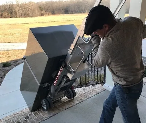 A man is moving a large metal object.