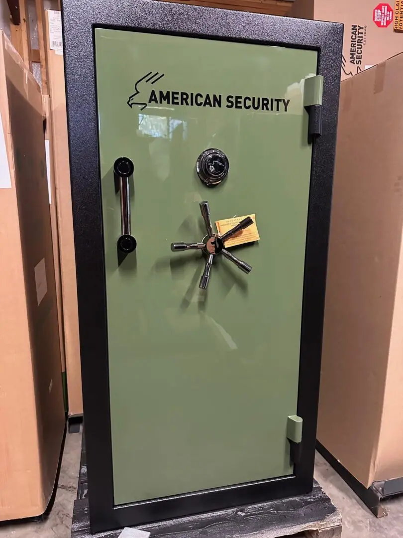 A green safe with keys on the door.