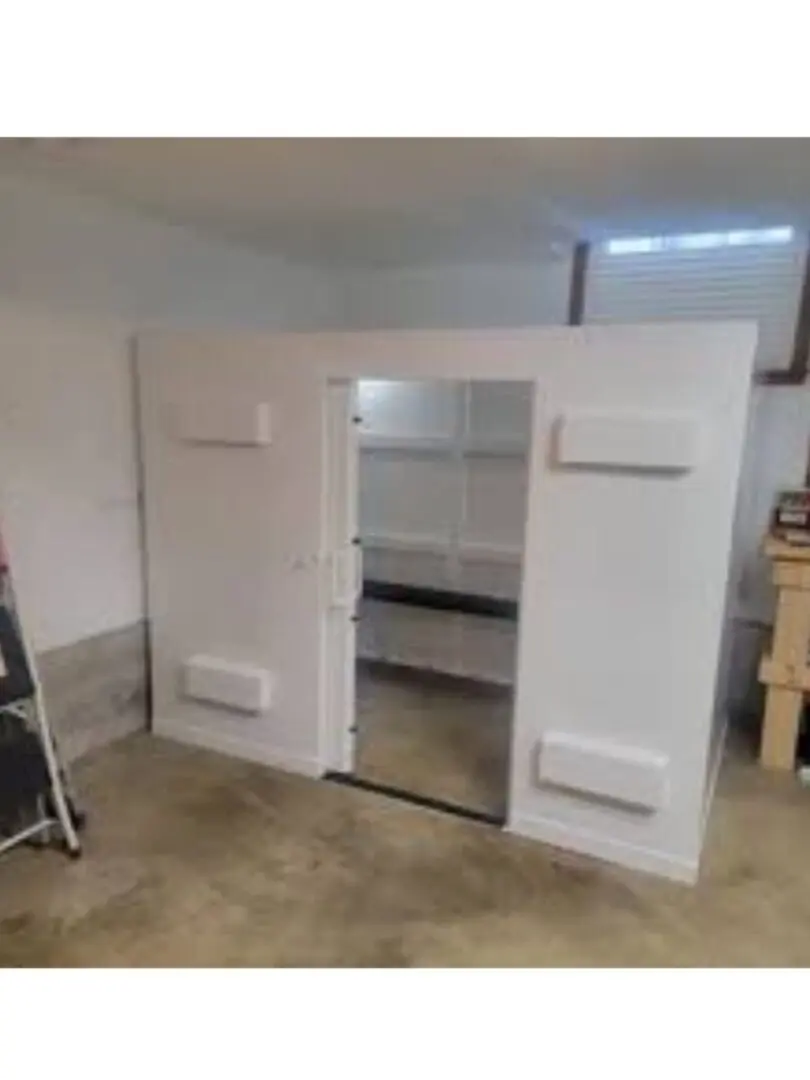 A room with two doors and shelves in it