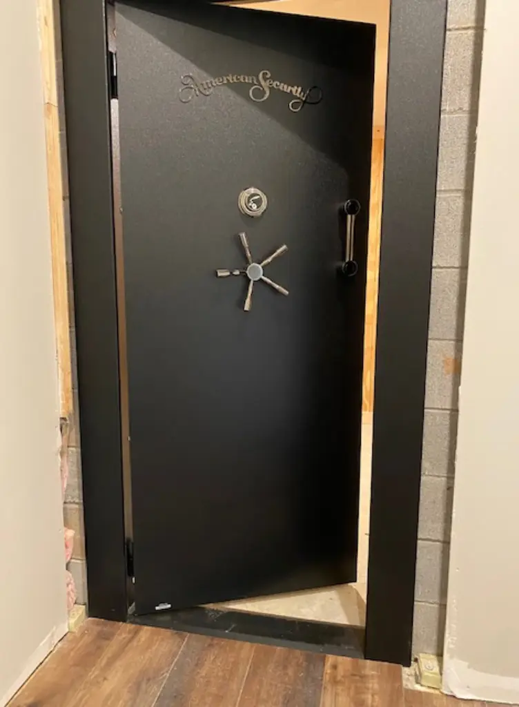 A black door with a clock on it.