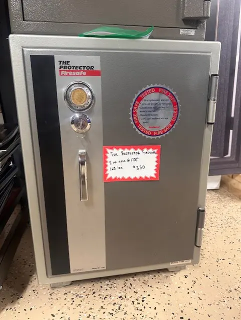 A metal cabinet with a clock and a thermometer on it.