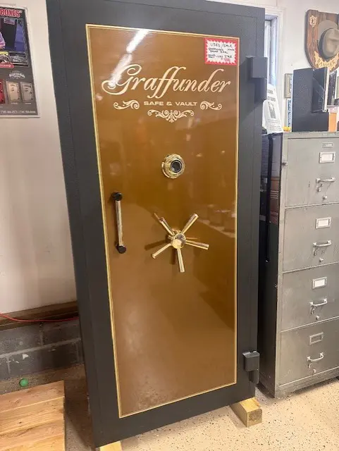 A large brown and black safe in a room.