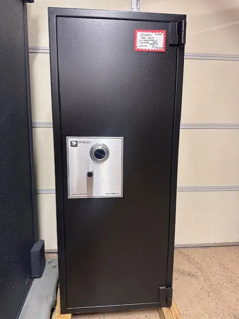 A black and silver safe in a room.