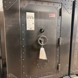 A large metal safe with a key on the door.