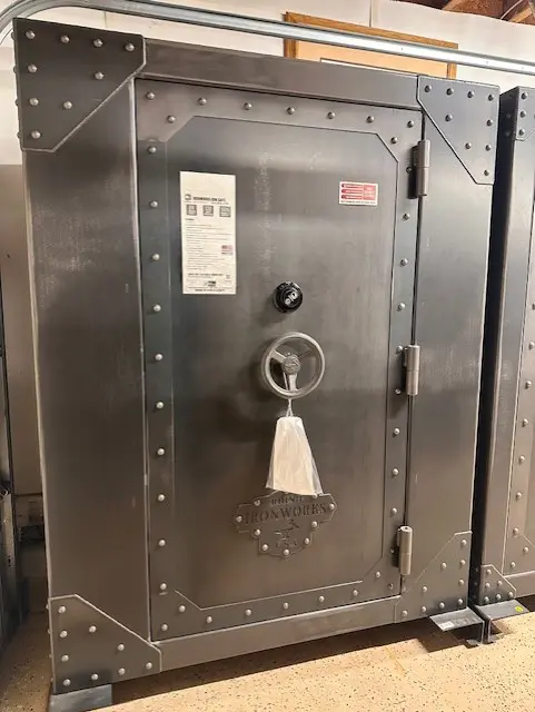 A large metal safe with a key on the door.