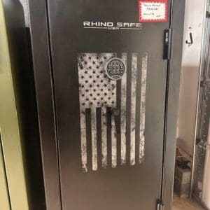 A black and silver safe with an american flag on it.