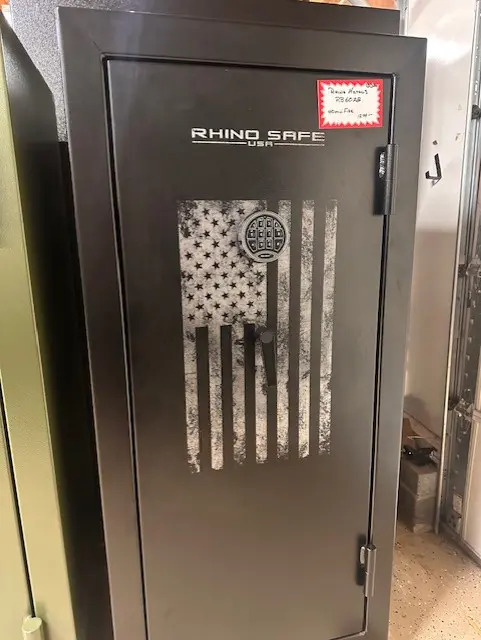 A black and silver safe with an american flag on it.