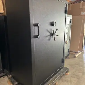 A large black safe sitting in the middle of a room.