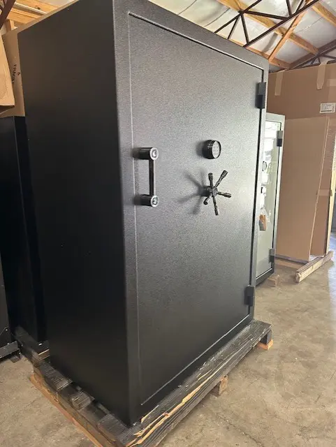 A large black safe sitting in the middle of a room.